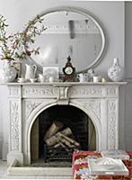 Open fireplace with ornamental surround & mirror a