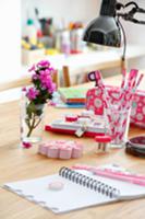 Various pink writing materials on table