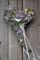 Dried flower heart against wooden background (top 