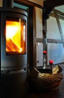 Wood basket next to wood-burning stove