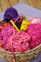 Wool basket with balls of wool, crocheting needle 