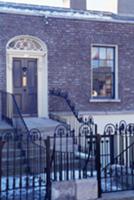 Wrought iron fence leading to front door of brick 