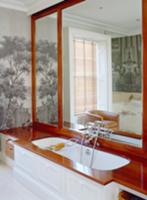 Bathtub with wooden surround in front of large mir