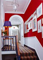 Stairs & landing with red and white walls & galler