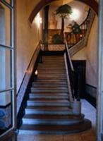 Candles on stone staircase in historic stairwell w