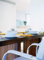 Festive dark wood table with place settings and up