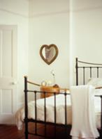 Traditional bedroom with antique-style metal bed a