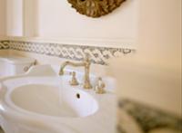 Curved sink with silver, antique-style tap fitting