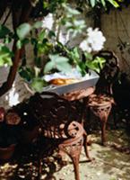 Small seating area on terrace with antique-style m