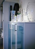 Modern kitchen cupboard with glass doors, spotligh