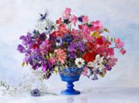 Colourful spring bouquet in blue vase against ligh