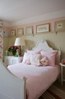 Bed with curved headboard and pink bed linen again