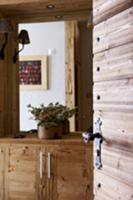 View of rustic, wooden sideboard through open inte