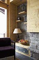 Corner of rustic, modern room with grey stone wall