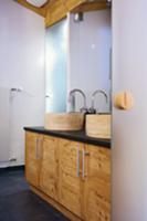 Modern bathroom with stone basins on wooden washst