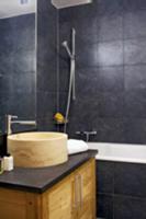 Modern bathroom with stone basin on washstand and 