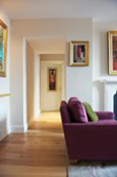 Purple sofa in living room with open doorway and v