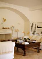 Antique coffee table and white sofas in front of o