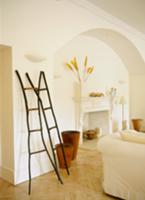 White living room with wooden objet leaning on wal