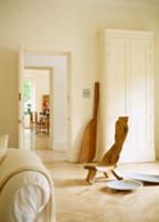 Hand-made, sculptural chair next to bowl on floor 