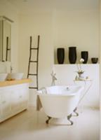 Vintage bathtub in centre of bathroom and group of