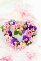 Heart-shaped flower wreath of violas and hyacinth 