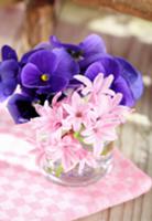 Posy of hyacinths and violas in water glass