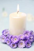 Candle with circlet of campanula flowers