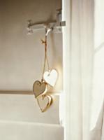 String with heart-shaped, wooden tags hanging on d