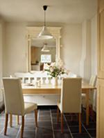 Chairs upholstered in white and wooden table on da