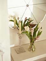 Bouquet of white tulips and candlestick on white s