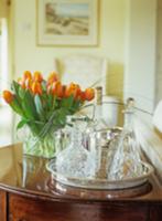 Crystal decanters on silver tray next to bouquet o