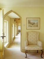 Baroque-style armchair next to open door with arch