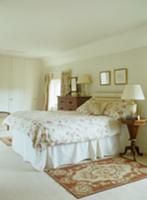 Traditional bedroom with floral throw on bed and B