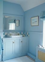 Bathroom painted light blue with fitted washstand 