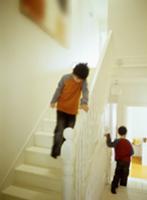 Children on white-painted, wooden staircase with t