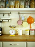 Vintage-style kitchen utensils hanging from stainl