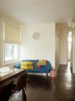 Blue sofa next to window in open-plan dining room