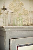 Collection of antique glass vases on shabby chic c