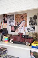 Vintage toy truck on shelf with family photos on s