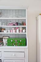 Glasses, cups and painted wooden case on white-pai