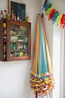 Colourful parasols and spice cabinet on wall in co