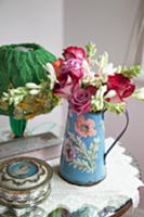 Vintage style, painted metal jug with bouquet of r