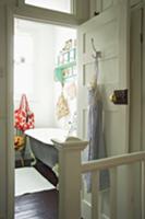 View into vintage bathroom through open door