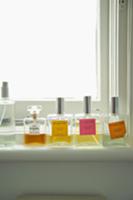 Various flagons of perfume on window sill