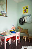 Pink children's chairs and table next to antique r