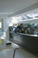 Kitchen counter with grey cupboard doors below sky