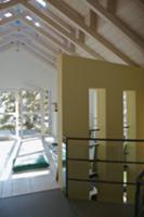 Open-plan attic room with white-painted wooden cei