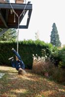 Child playing on rope attached to roof terrace str