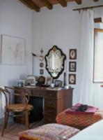 Antique desk with drawers and curved wood armchair